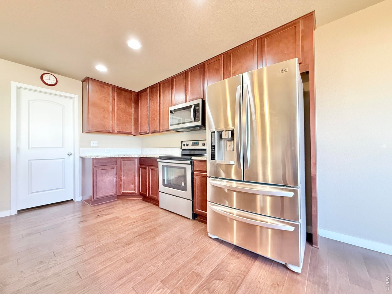 640 Cimarron Trail Ault, CO 80610 - Photo 4 of 15 a kitchen with granite countertop stainless steel appliances and wooden cabinets