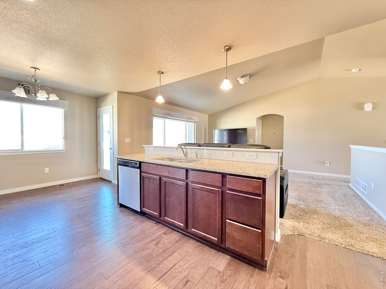 640 Cimarron Trail Ault, CO 80610 - Photo 5 of 15 a large kitchen with stainless steel appliances granite countertop a large stove a sink dishwasher and a oven with wooden floor