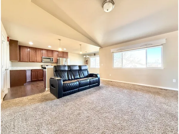 a living room with a couch and a kitchen counter top space