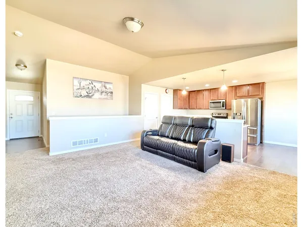 a view of a livingroom with furniture and a flat screen tv