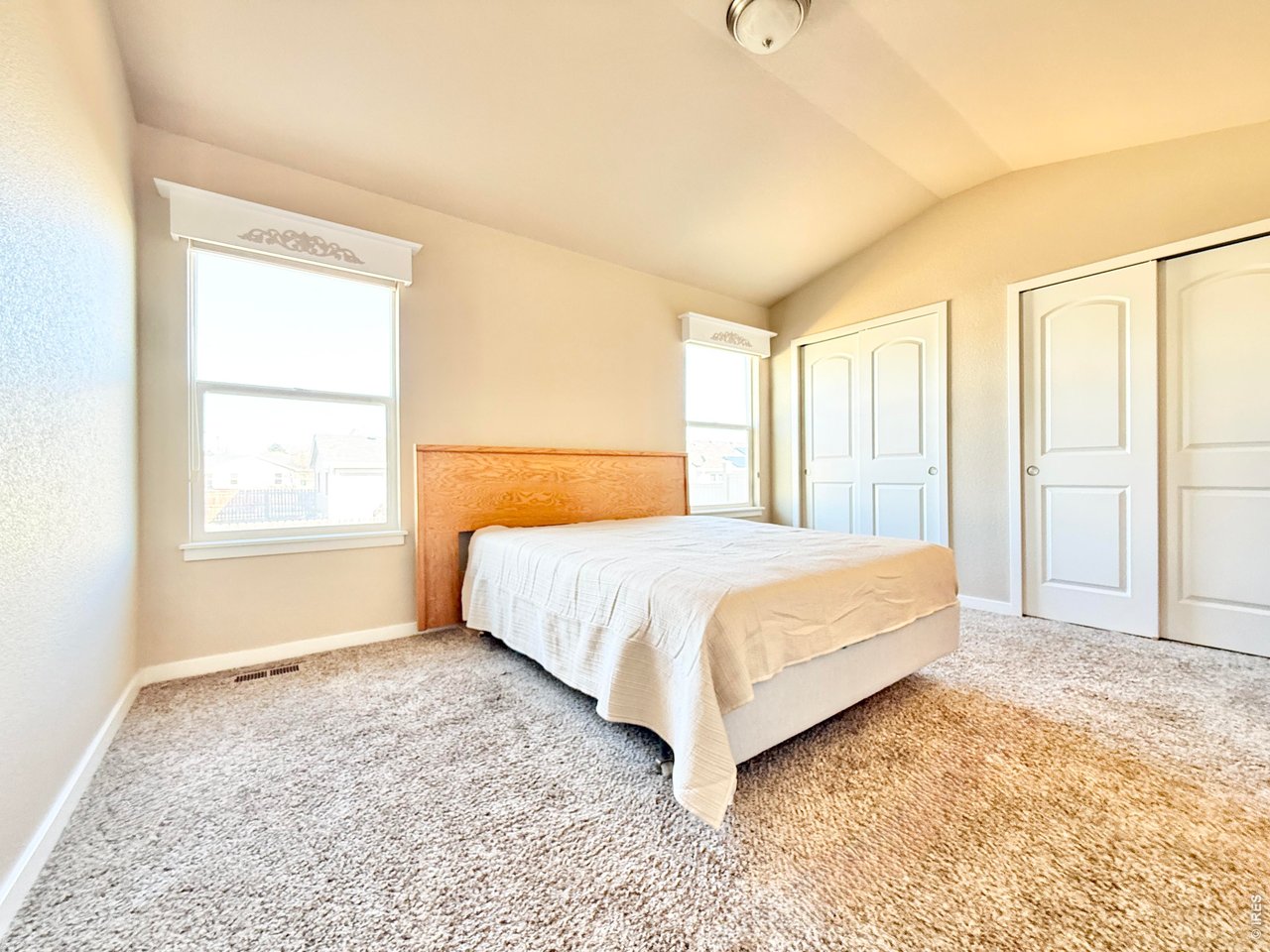 640 Cimarron Trail Ault, CO 80610 - Photo 8 of 15 a bedroom with a bed and a window