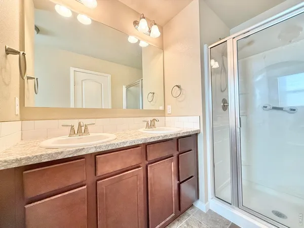 a bathroom with a granite countertop sink mirror and double