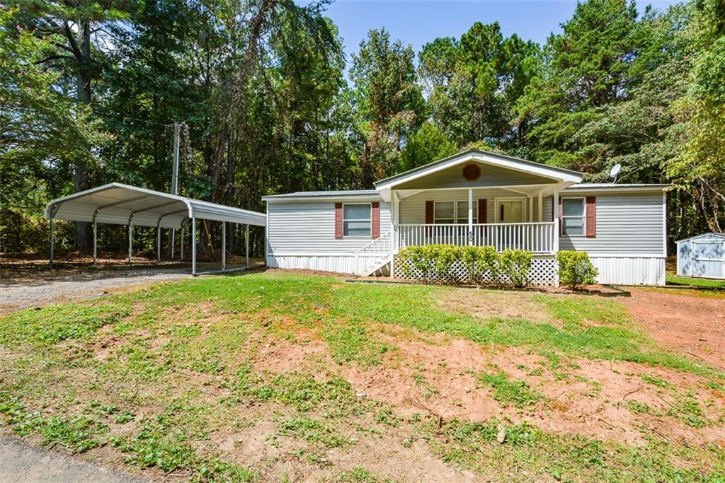 a front view of a house with yard and green space