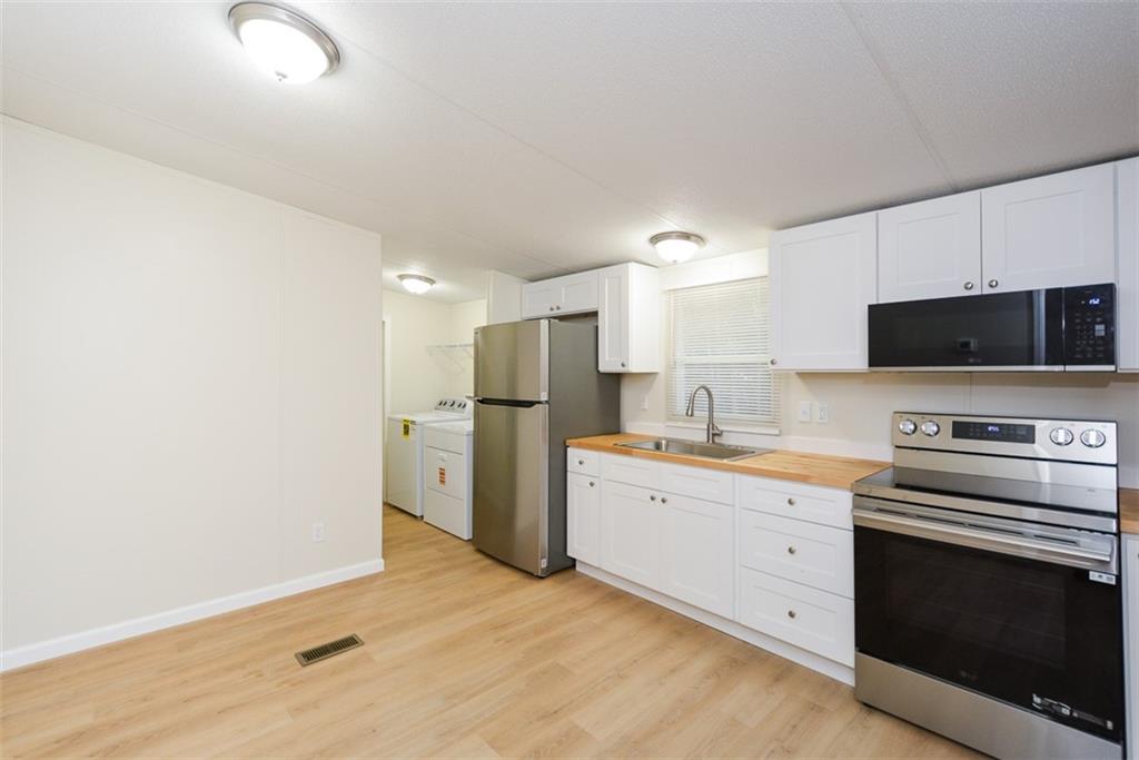 50 Damascus Road Talking Rock, GA 30175 - Photo 14 of 39 a kitchen with stainless steel appliances a stove microwave and refrigerator