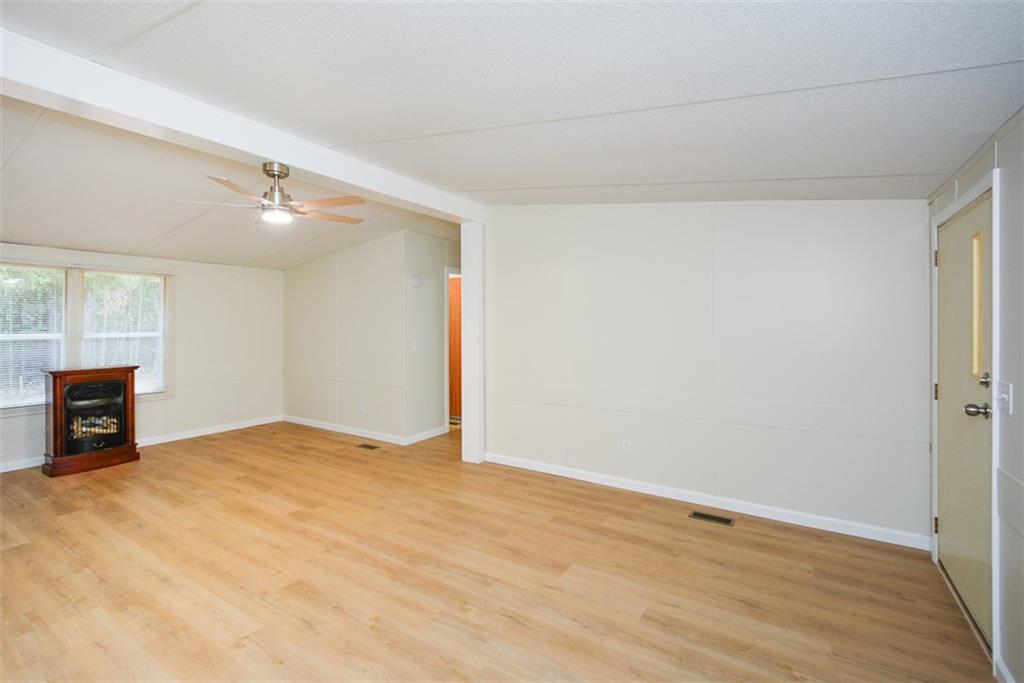 50 Damascus Road Talking Rock, GA 30175 - Photo 8 of 39 a view of an empty room with a fireplace and a window