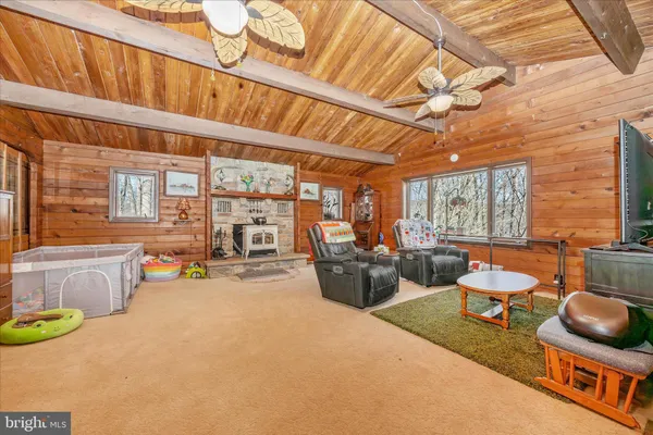a living room with furniture a flat screen tv and a large window