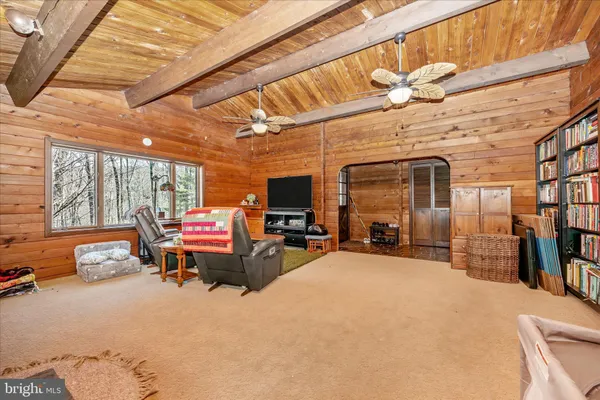 a living room with furniture stove and flat screen tv