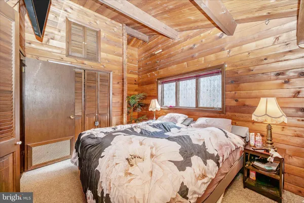 a bed sitting in a bedroom next to a window