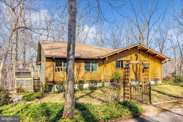 a view of a house with yard and sitting area