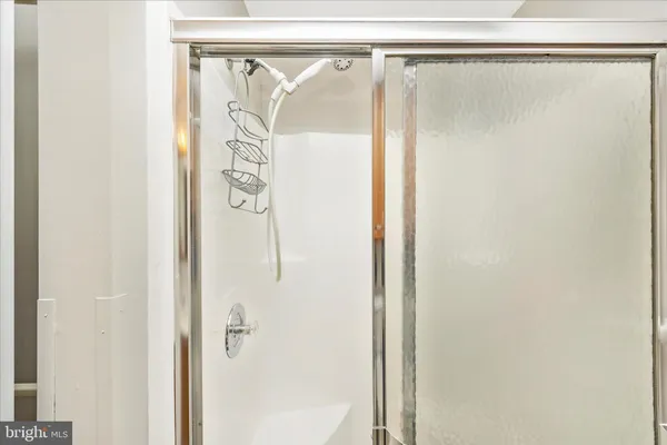 a bathroom with a glass shower door