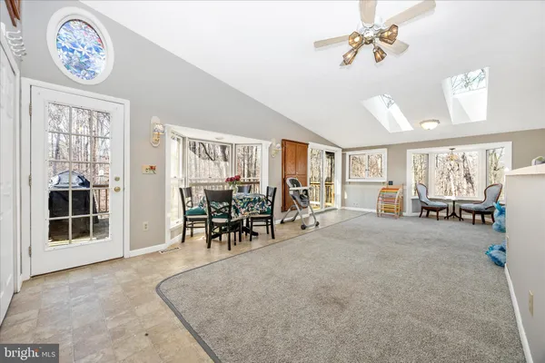 a view of a livingroom with furniture and a window
