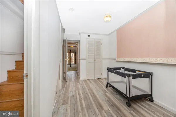 a view of a refrigerator in kitchen and an empty room