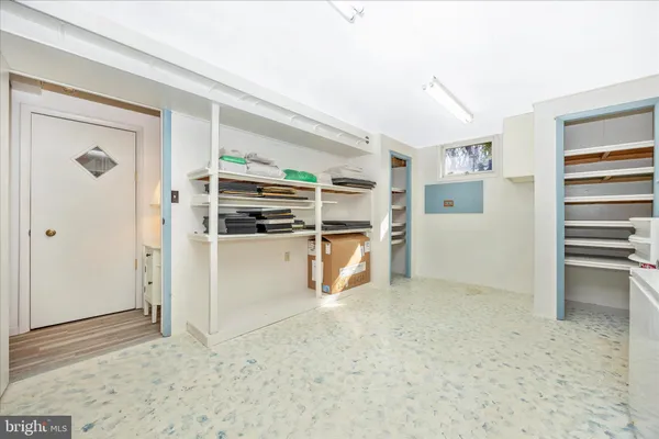 a view of kitchen with refrigerator and window