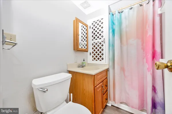 a bathroom with a toilet sink and curtain