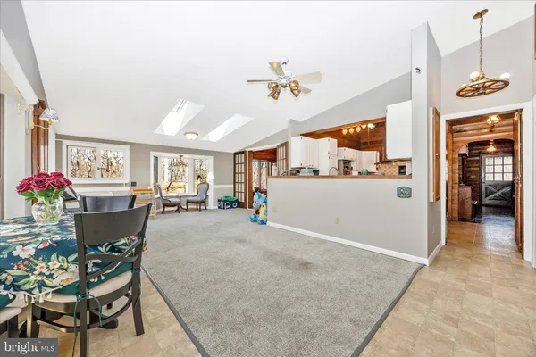 a view of a livingroom with furniture and a ceiling fan