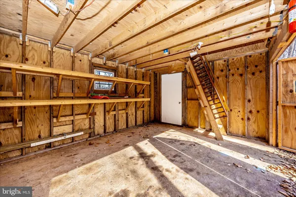a view of a garage with wooden walls