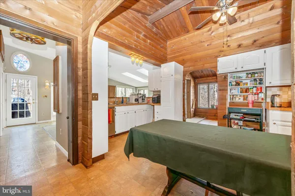 a living room with lots of furniture and a kitchen view