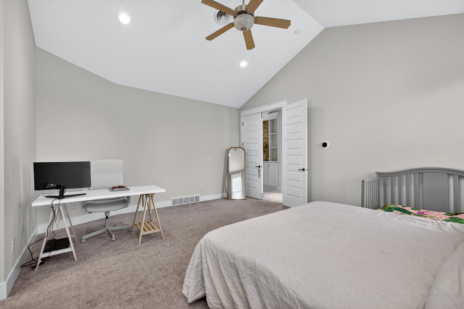 5700 Emily Road Bettendorf, IA 52722 - Photo 31 of 58 a bedroom with a bed a desk and a chandelier
