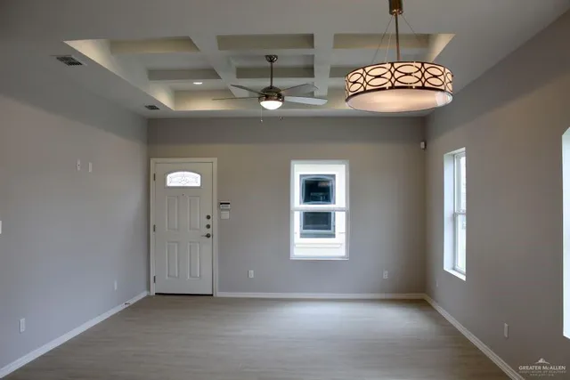 a view of a livingroom with a chandelier furniture and windows