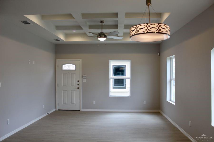 1901 Jackson Street, Unit 4 Weslaco, TX 78599 - Photo 7 of 10 a view of a livingroom with a chandelier furniture and windows