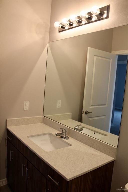 1901 Jackson Street, Unit 4 Weslaco, TX 78599 - Photo 9 of 10 a bathroom with a sink and a mirror