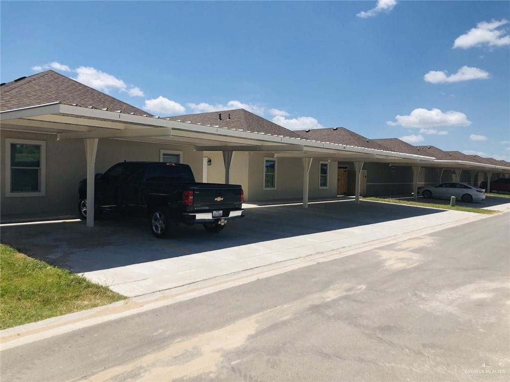 1901 Jackson Street, Unit 4 Weslaco, TX 78599 - Photo 10 of 10 a front view of a house with a yard and garage
