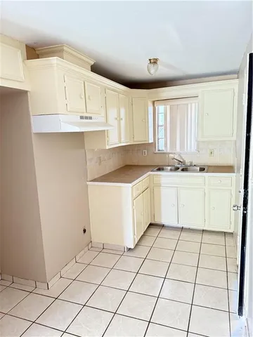 a kitchen with white cabinets