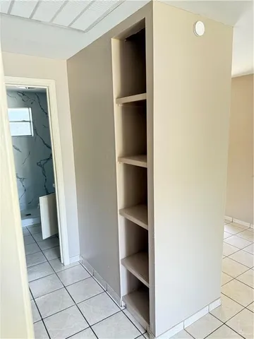 a view of an empty room with a window