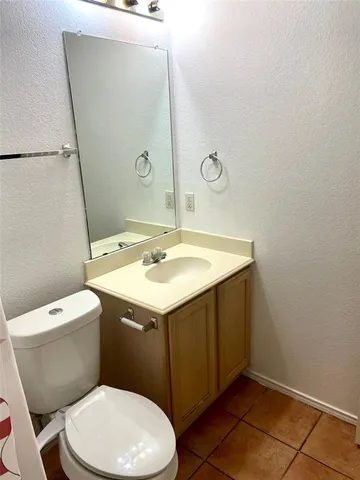 a bathroom with a sink mirror vanity and toilet