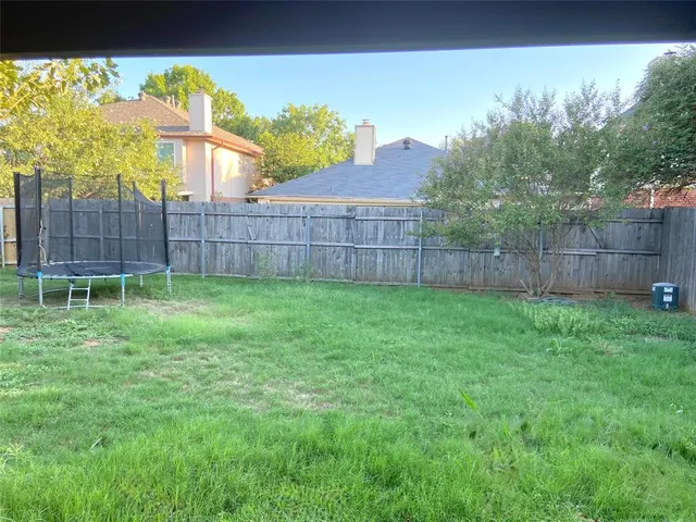a view of a backyard with a garden and plants