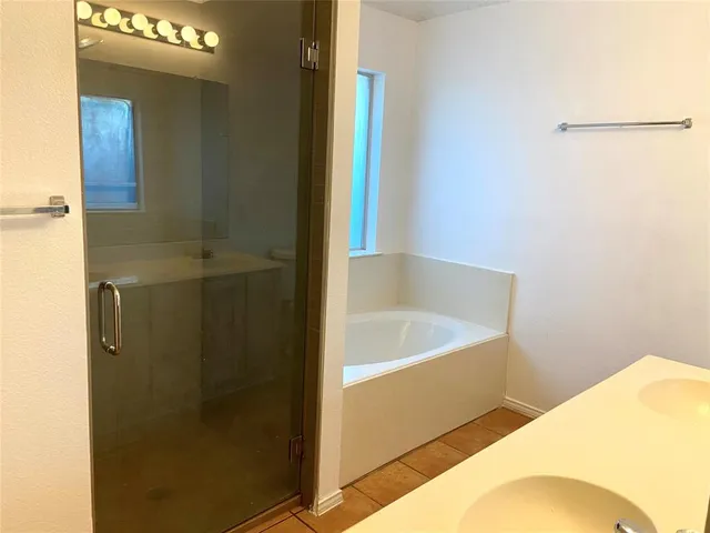 a bathroom with a tub and shower