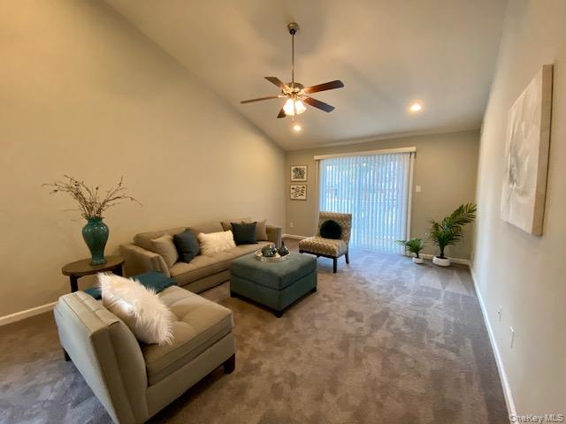 32 Country Club Drive, Unit 32C Coram, NY 11727 - Photo 4 of 8 a living room with furniture and a ceiling fan