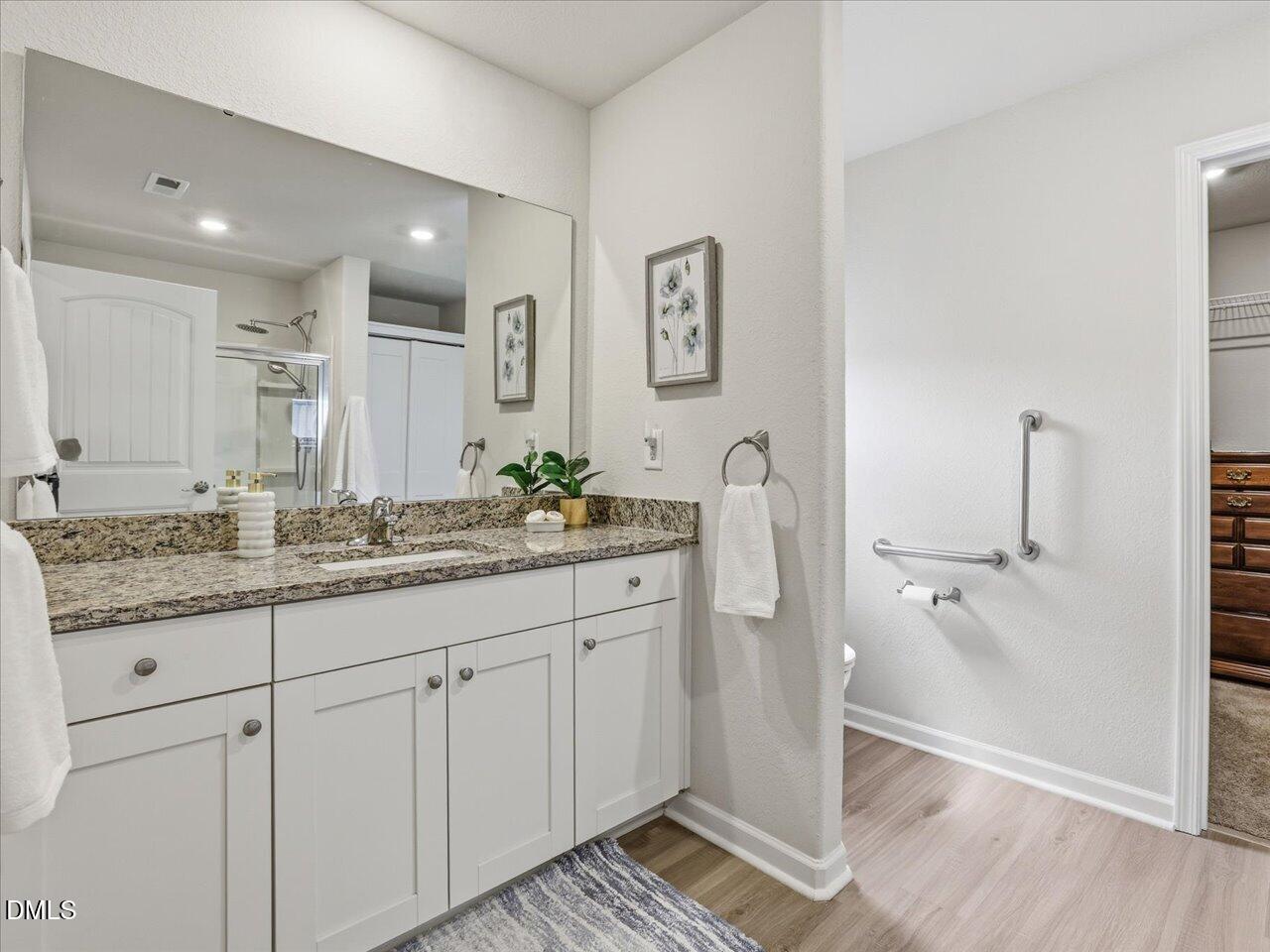90 Barnsley Road Angier, NC 27501 - Photo 22 of 40 a bathroom with a granite countertop sink and a mirror