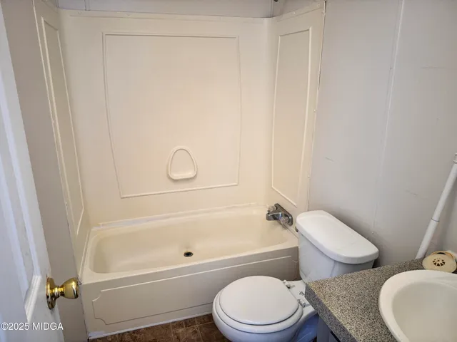 a bathroom with a toilet and a bathtub