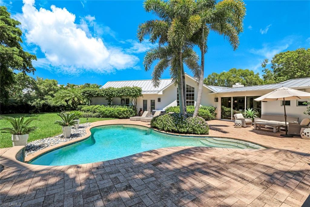 Outdoor pool featuring a patio, an outdoor hangout area, a sunroom, and french doors