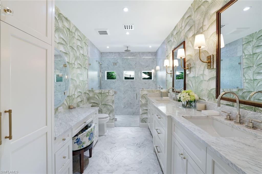 642 6th Avenue North Naples, FL 34102 - Photo 14 of 25 Full bathroom featuring double vanity, a marble finish shower, light marble finish floors, recessed lighting, and tile walls