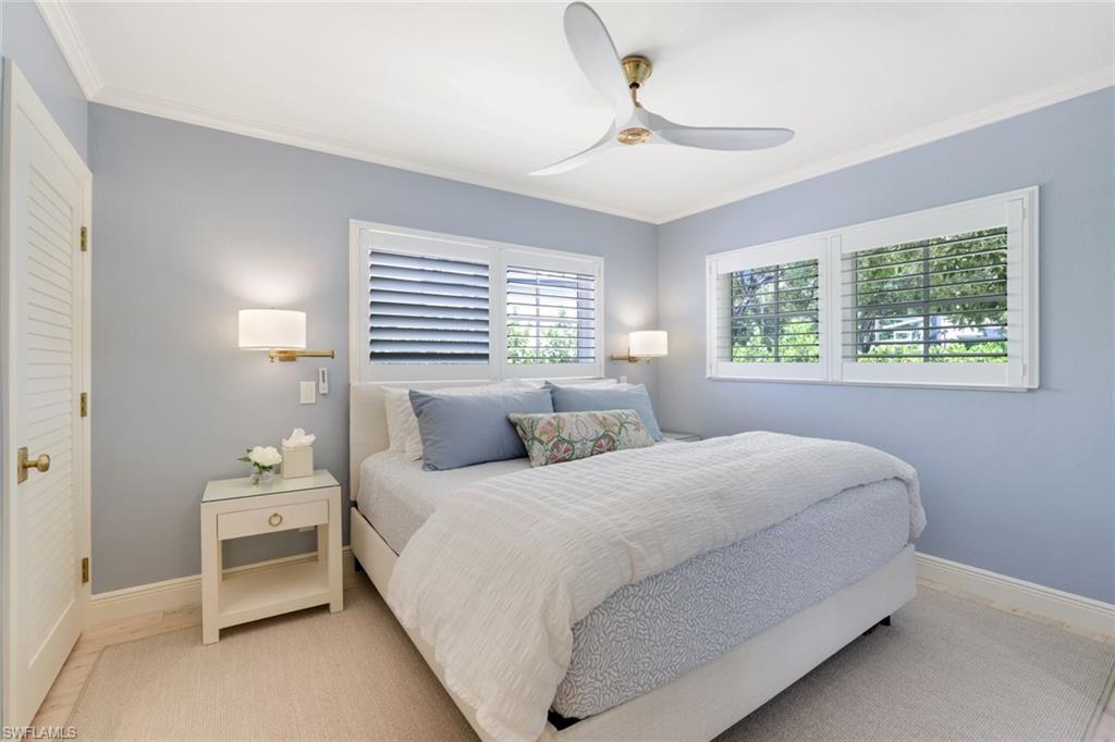 642 6th Avenue North Naples, FL 34102 - Photo 18 of 25 Bedroom featuring crown molding and ceiling fan