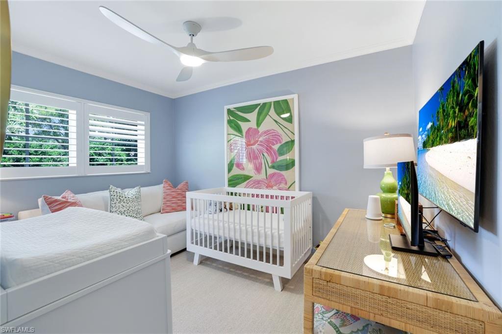 642 6th Avenue North Naples, FL 34102 - Photo 22 of 25 Bedroom with ornamental molding and ceiling fan
