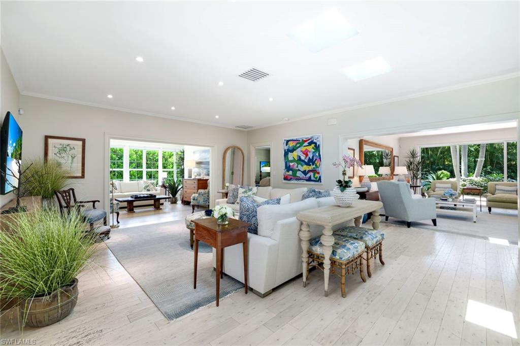 642 6th Avenue North Naples, FL 34102 - Photo 5 of 25 Living area featuring crown molding, light wood-type flooring, plenty of natural light, and recessed lighting