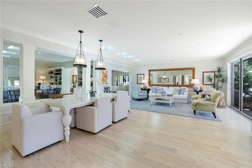 642 6th Avenue North Naples, FL 34102 - Photo 7 of 25 Living area featuring light wood-style floors and crown molding