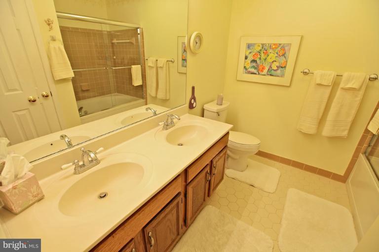 1521 Church Hill Place, Unit 1521 Reston, VA 20194 - Photo 12 of 20 a bathroom with a sink mirror and a toilet