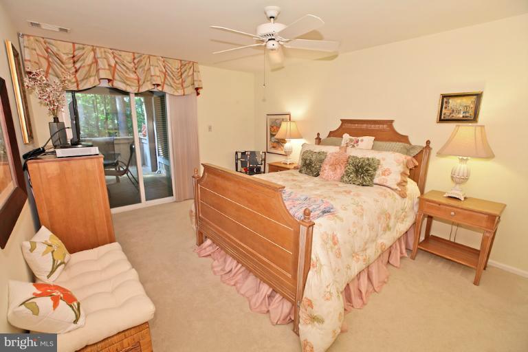 1521 Church Hill Place, Unit 1521 Reston, VA 20194 - Photo 18 of 20 a bedroom with a bed and a couch