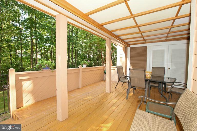 1521 Church Hill Place, Unit 1521 Reston, VA 20194 - Photo 3 of 20 a view of a patio with table and chairs and wooden floor