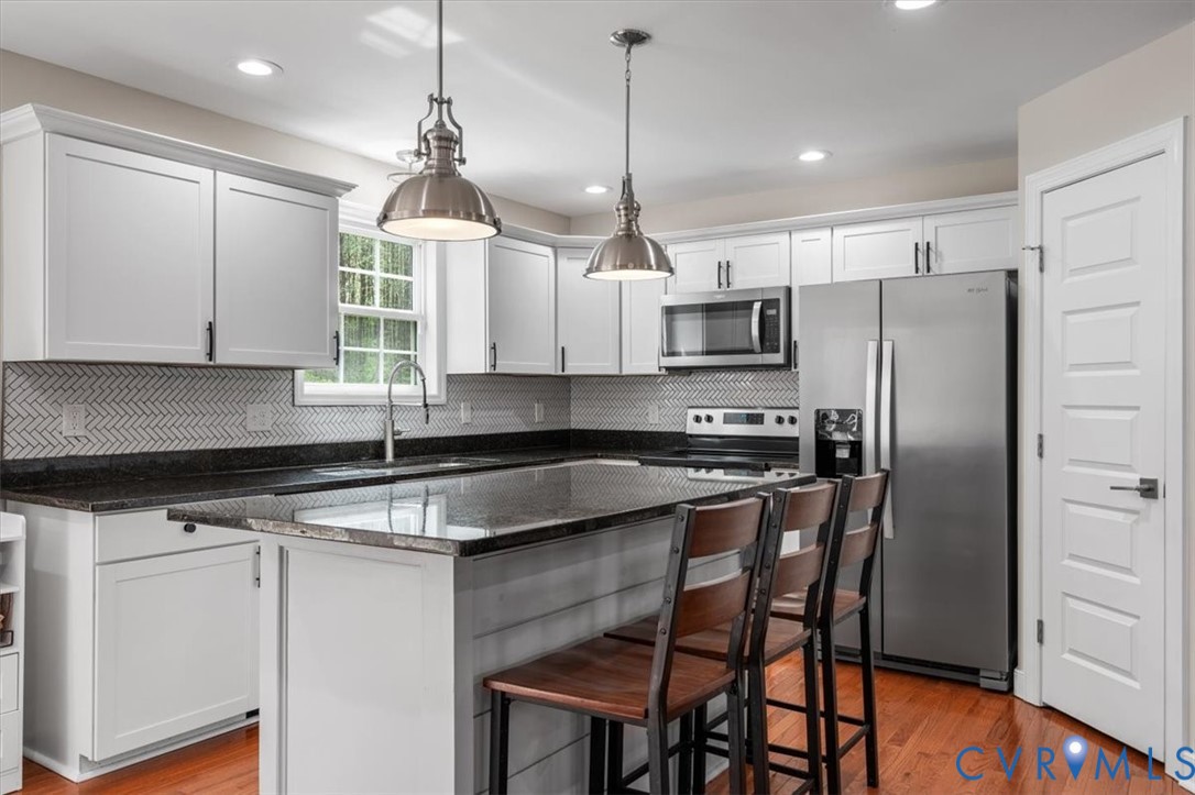 1290 Scotts Court Carson, VA 23830 - Photo 11 of 46 a kitchen with stainless steel appliances granite countertop a stove a sink and a refrigerator