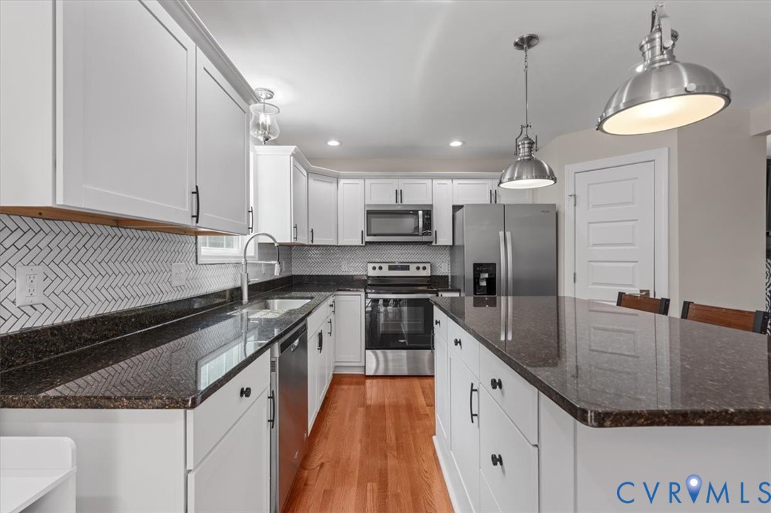 1290 Scotts Court Carson, VA 23830 - Photo 13 of 46 a large kitchen with granite countertop a sink a counter space appliances and cabinets