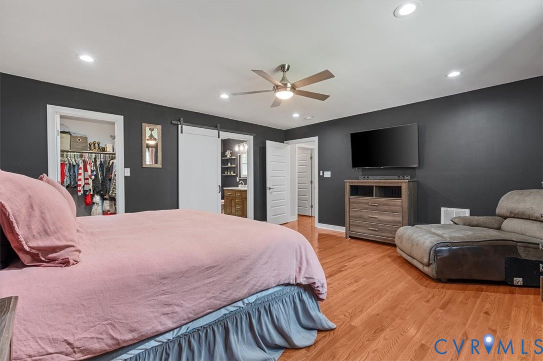 1290 Scotts Court Carson, VA 23830 - Photo 20 of 46 a bedroom with a bed and a flat screen tv