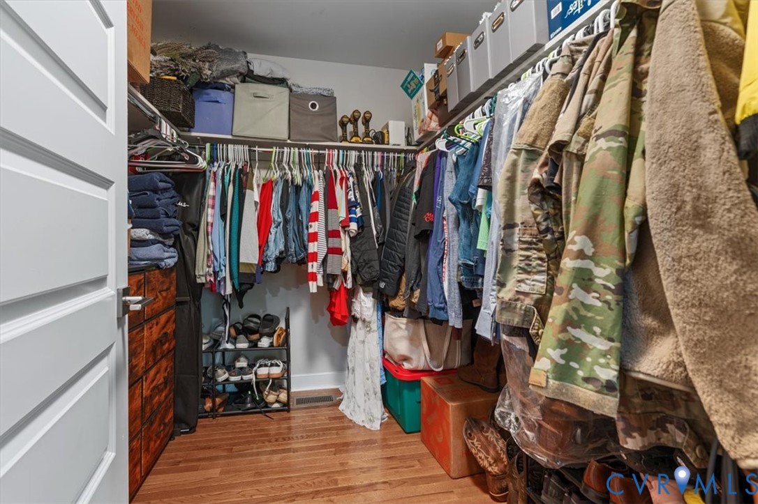 1290 Scotts Court Carson, VA 23830 - Photo 22 of 46 a view of walk in closet with clothes and shoes