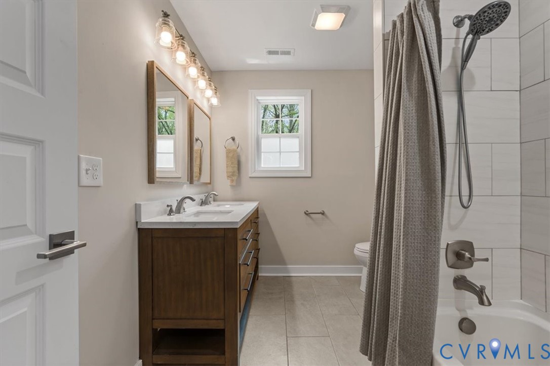 1290 Scotts Court Carson, VA 23830 - Photo 29 of 46 a bathroom with a sink a toilet and shower