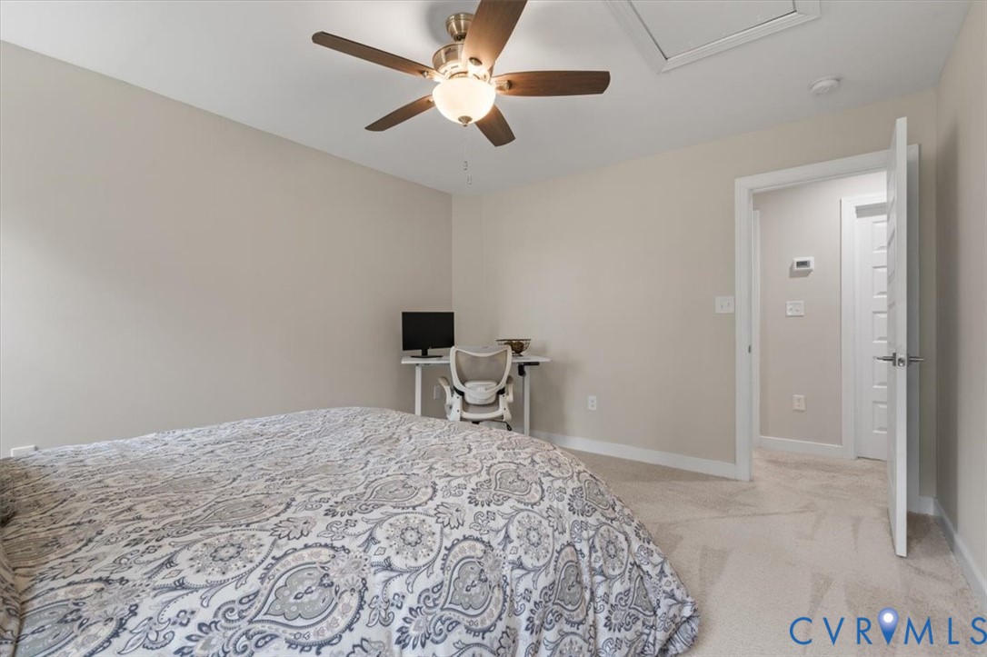 1290 Scotts Court Carson, VA 23830 - Photo 31 of 46 a bedroom with a bed and a chair with the view of bathroom