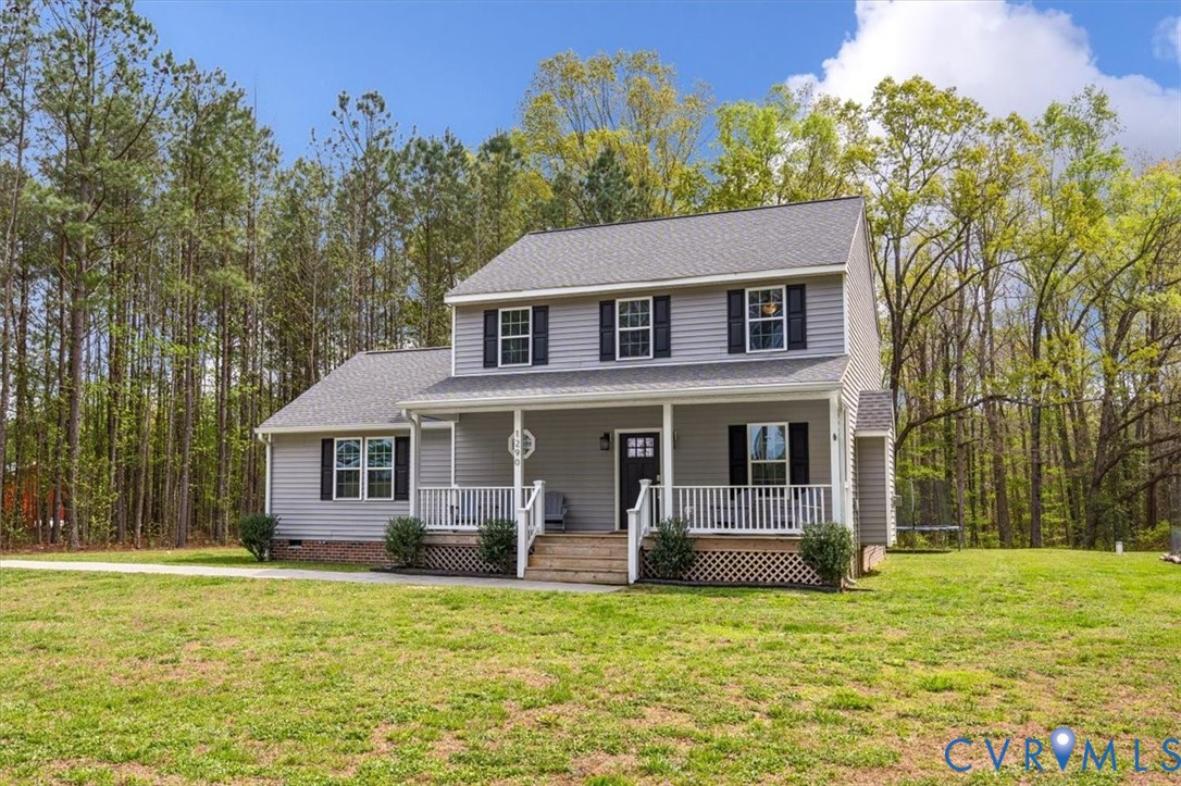 1290 Scotts Court Carson, VA 23830 - Photo 45 of 46 a front view of a house with a garden and trees